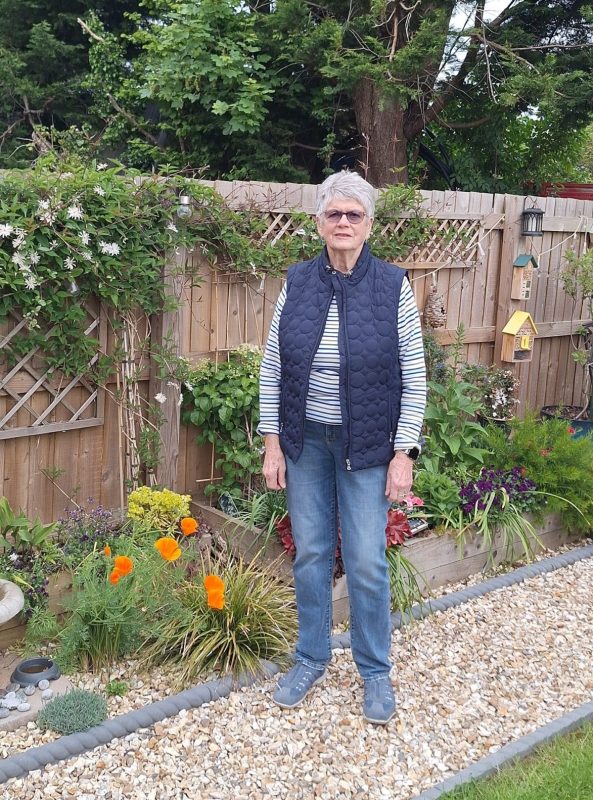 Photo of Daf in her garden who won Stonewater's Individual Garden category in their annual Gardening Competition